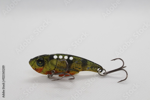 Metal cicada fishing lure isolated on a white background. Fishing lures on white background. Fishing fake bait are another alternative to angling photo