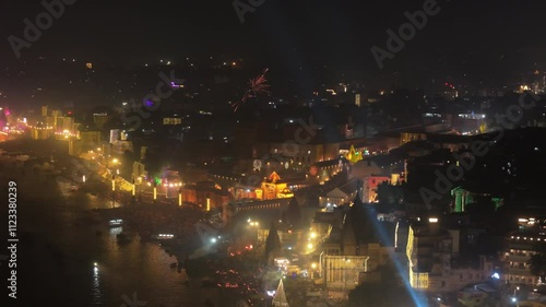 Aerial shot of banaras in dev diwali with Manikarnika Ghat Kashi Vishwanath Temple and Gyanvapi Mosque with Ghats River Ganga and Small Ships or boats Glowing City