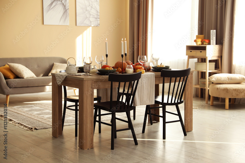 Fototapeta premium Stylish dining room with beautiful table setting and autumn decor