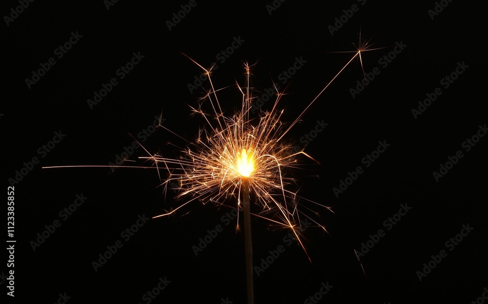 Burning sparkler on black background, space for text Burning sparkler on black background, space for text