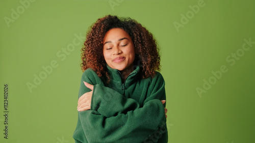 Фотография Girl in cozy green sweater in studio, concept of coziness and warmth