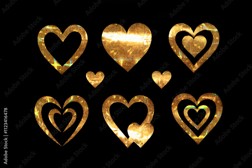 Obraz premium Collection of golden hearts on a black background. Metal hearts with glitter and glitter. Packaging for February 14th. Valentine's day