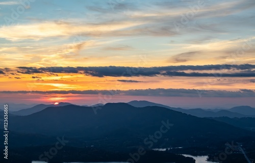 Various stages of the sunset over Lake Hiawassee from the summit of Bell Rock Mountain in Hiawassee, Georgia photo