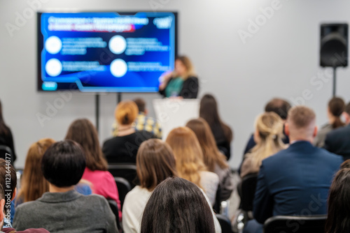 Wallpaper Mural Blurred view of conference audience focused on speaker and presentation screen in lecture hall. Torontodigital.ca