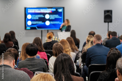 Wallpaper Mural Business conference with speaker presenting to diverse audience in modern auditorium setting. Torontodigital.ca