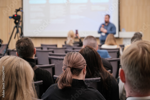 Wallpaper Mural Audience attentively listening to speaker during business presentation at conference. Focus on interaction, professional growth, and learning environment. Torontodigital.ca