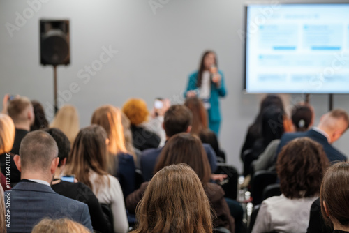 Wallpaper Mural Conference scene with a speaker addressing engaged audience focused on presentation content. Torontodigital.ca