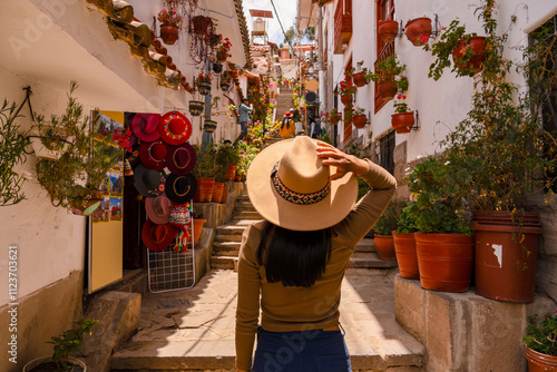 Latin tourist walking down 7 Borreguitos street in Cusco
