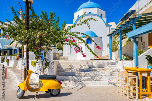 Obraz na płótnie Yellow scooter and traditional Greek style white church in Apollonas village, Naxos island, Cyclades, Greece w salonie