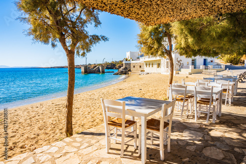 Tables with chairs in Greek taverna restaurant on beach in Motsouna village, Naxos island, Cyclades, Greece