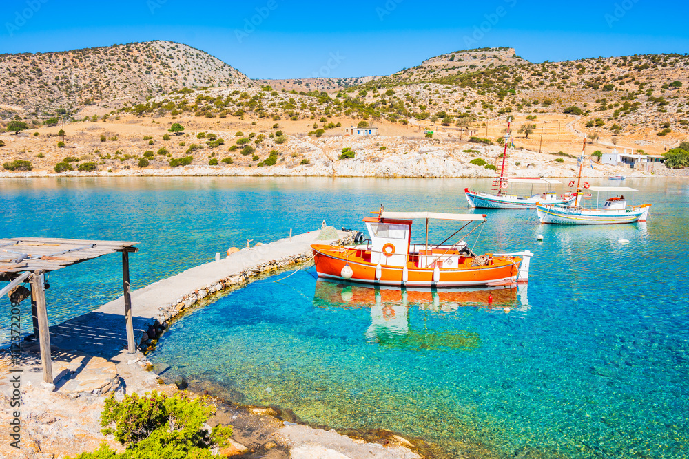Fishing boats on azure sea and palm trees on idyllic Panormos beach, Naxos island, Cyclades, Greece