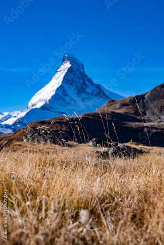 Autumn landscape of high alpine mountains in Switzerland with Matterhorn in the background