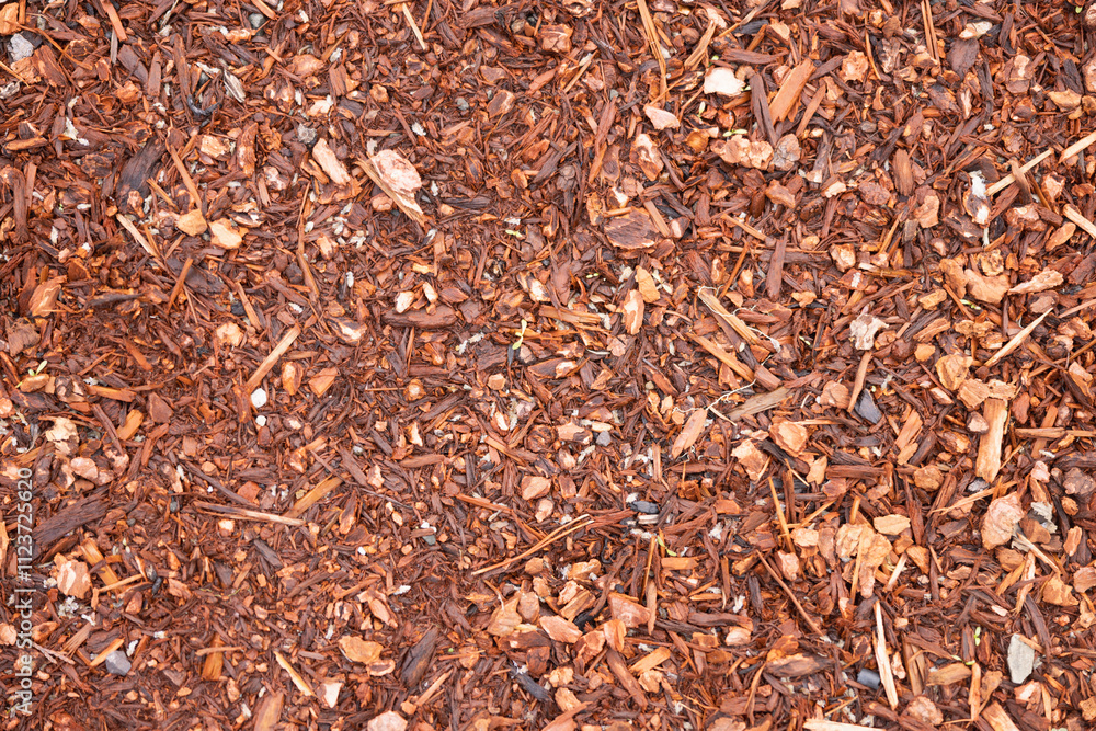 Fototapeta premium Red bark mulch laying on a flat surface