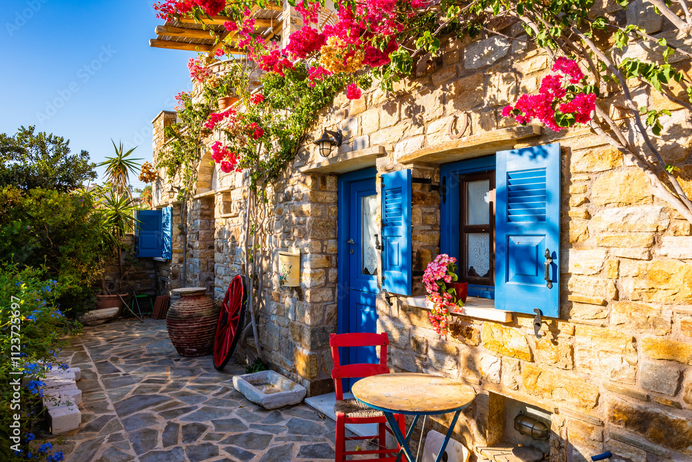 Typical Greek style apartments decorated with colorful flowers in Galini village, Naxos island, Cyclades, Greece