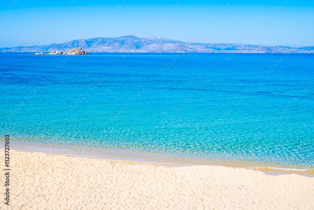 Wonderful sandy beach of Orkos bay and calm azure sea water