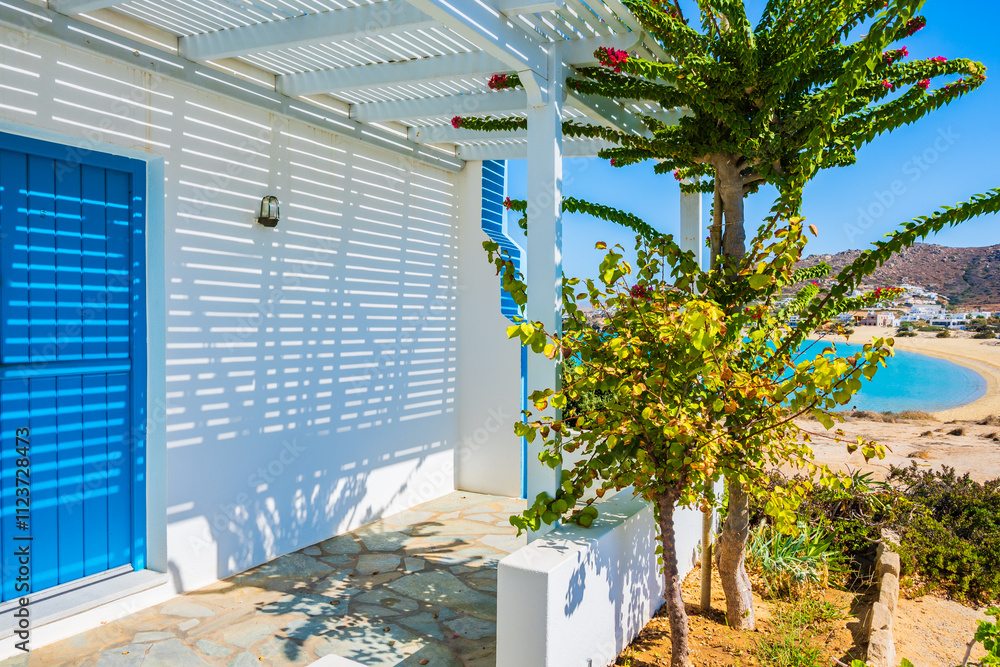Typical Greek style apartments decorated with tropical plants in Orkos bay, Naxos island, Cyclades, Greece