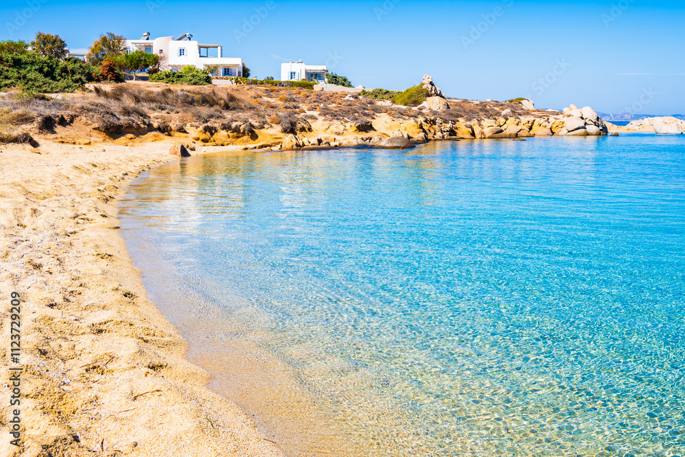 Idyllic sandy beach of Orkos bay and calm crystal clear azure sea water, Naxos island, Cyclades, Greece