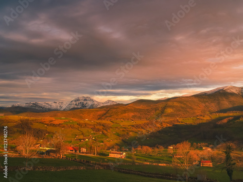 Views of San Pedro del Romeral at sunset with Castro Valnera in the background