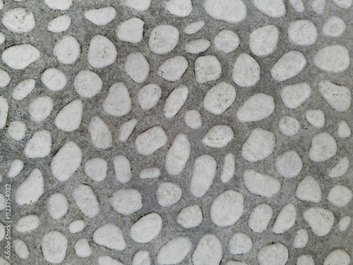 Sidewalk made of pebble stones and gravel in gray and white in French, English and Japanese style. Old European gardens. Raw, good for wrapping 3D models. Top shot, close up, micro patterned texture