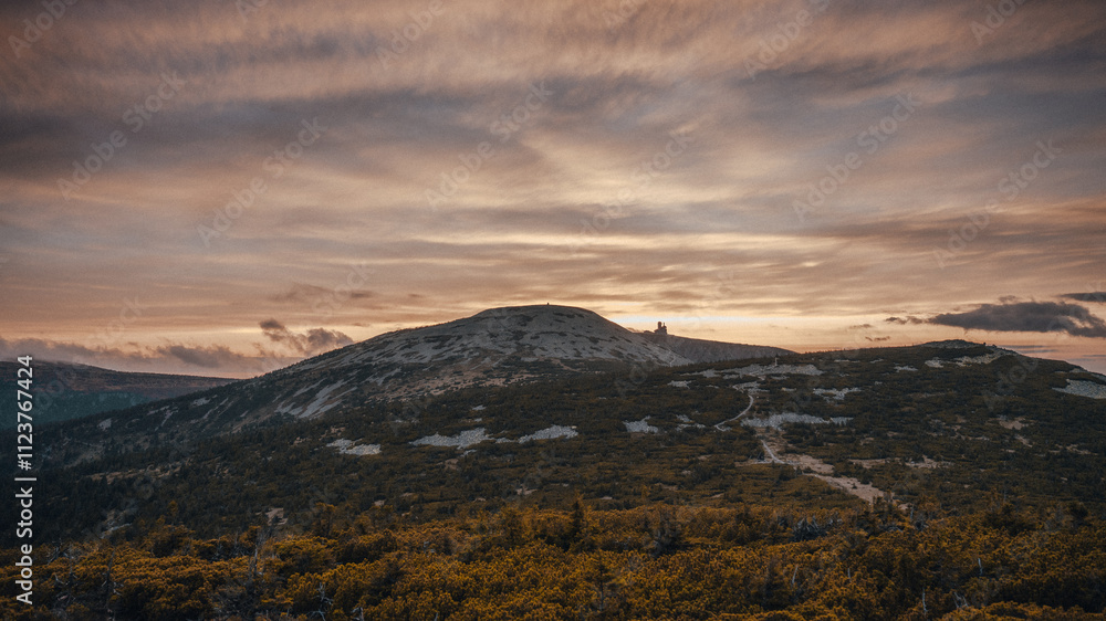Fototapeta premium A rugged and rocky hillside with a cloudy sky in the distant background