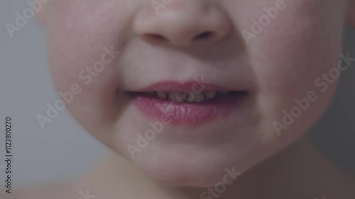 Boy smiles brightly wobbly milk tooth joy of carefree childhood and charm of youthful change. Close-up of child's smile loose milk tooth visible carefree nature of childhood natural progression