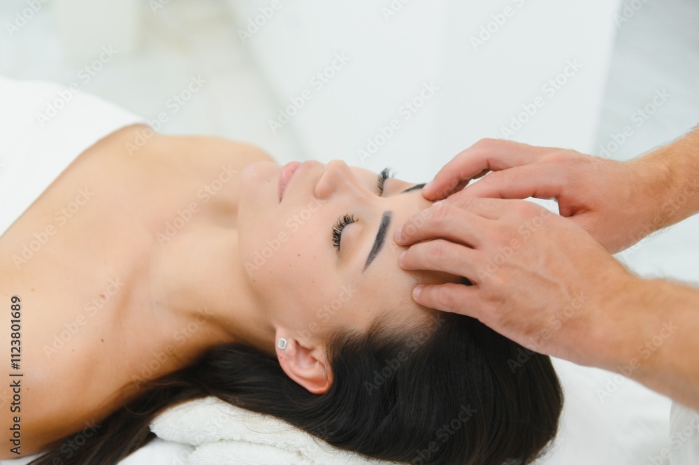 Fototapeta premium Theres no better way to relax. Shot of an attractive woman enjoying a face massage