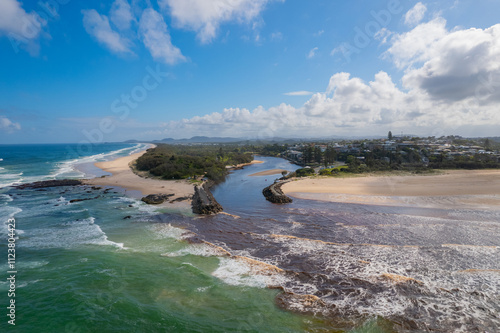 Aerial views of muddy waters from Cudgen Creek flowing in to the sea at Kingscliff headland seawall along the east coast of New South Wales, Australia photo