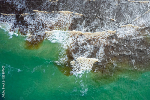 Aerial views of muddy waters from Cudgen Creek flowing in to the sea at Kingscliff headland seawall along the east coast of New South Wales, Australia photo