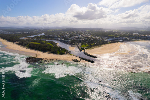 Aerial views of muddy waters from Cudgen Creek flowing in to the sea at Kingscliff headland seawall along the east coast of New South Wales, Australia photo