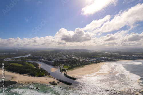 Aerial views of muddy waters from Cudgen Creek flowing in to the sea at Kingscliff headland seawall along the east coast of New South Wales, Australia photo