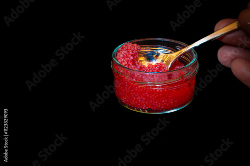 Obraz na płótnie red lumpfish roe in a glass jar against black background w salonie