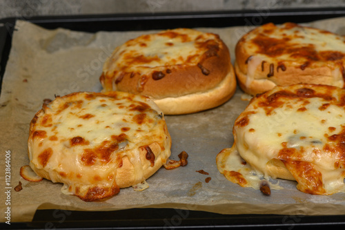 Melting cheese and savory toppings create a mouthwatering delight in an oven-baked dish photo