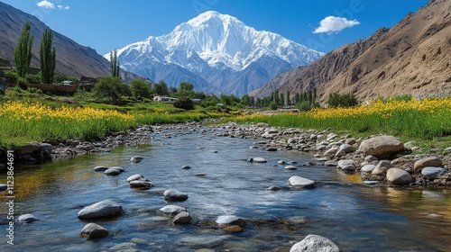 A serene river flows through a valley with mountains and vibrant flowers under a blue sky.