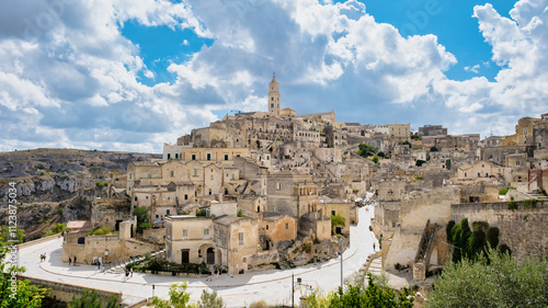 Nestled in the hills of Puglia Italy, Matera boasts ancient stone houses and winding streets, bathed in golden sunlight. A stunning blend of history and scenic beauty creates an enchanting atmosphere.