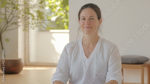 A womanon the yoga mat, white background photo