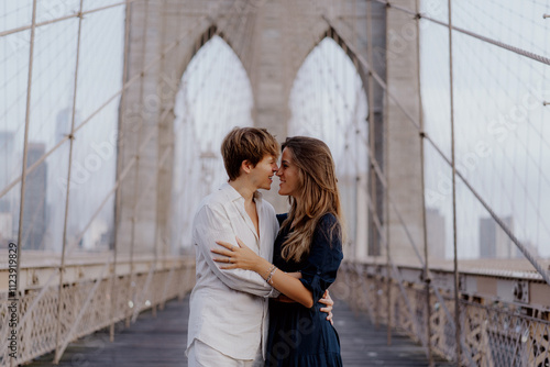 A loving couple shares a romantic moment on the iconic Brooklyn Bridge, capturing their extraordinary bond