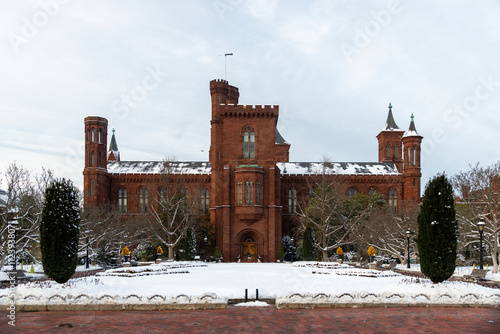 Smithsonian Institution Castle in Winter: Snow-Covered Historic Landmark in Washington D.C. photo