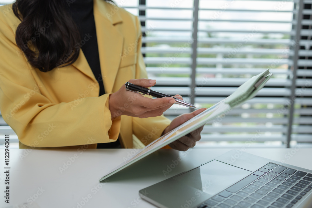 Obraz premium a female executive office working is sitting and working in her private office, a female company owner sits in her company's office, entrepreneur, businesswoman works with a lot of paperwork