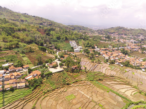 Majestic Ridge in the Cicalengka highlands, Indonesia. Gentle slopes with panoramic rice fields and villages along the valley. Countryside View. Drone Aerial. Landscape Photography photo