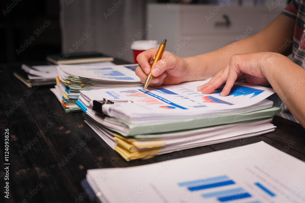 A man working late at home sits at his desk analyzing financial charts, checking stock market data on a laptop, tablet, and mobile, surrounded by informal, technology-driven tools. A man working late at home sits at his desk analyzing financial charts, checking stock market data on a laptop, tablet, and mobile, surrounded by informal, technology-driven tools.