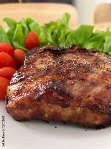 Close-up of medium rare steak with fork lifting the piece to reveal the juicy interior. photo