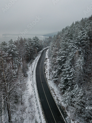 highway in the mountains in winter with fog