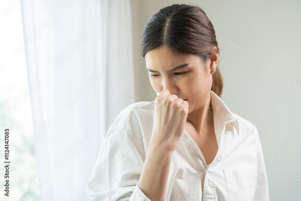 Bad smell nose concept asian young housewife woman having smelling clothes her shirt collar, sniff smelly dirty stinky musty, look disgusting from clothes after washed, laundry out of machine at home. Bad smell nose concept asian young housewife woman having smelling clothes her shirt collar, sniff smelly dirty stinky musty, look disgusting from clothes after washed, laundry out of machine at home.