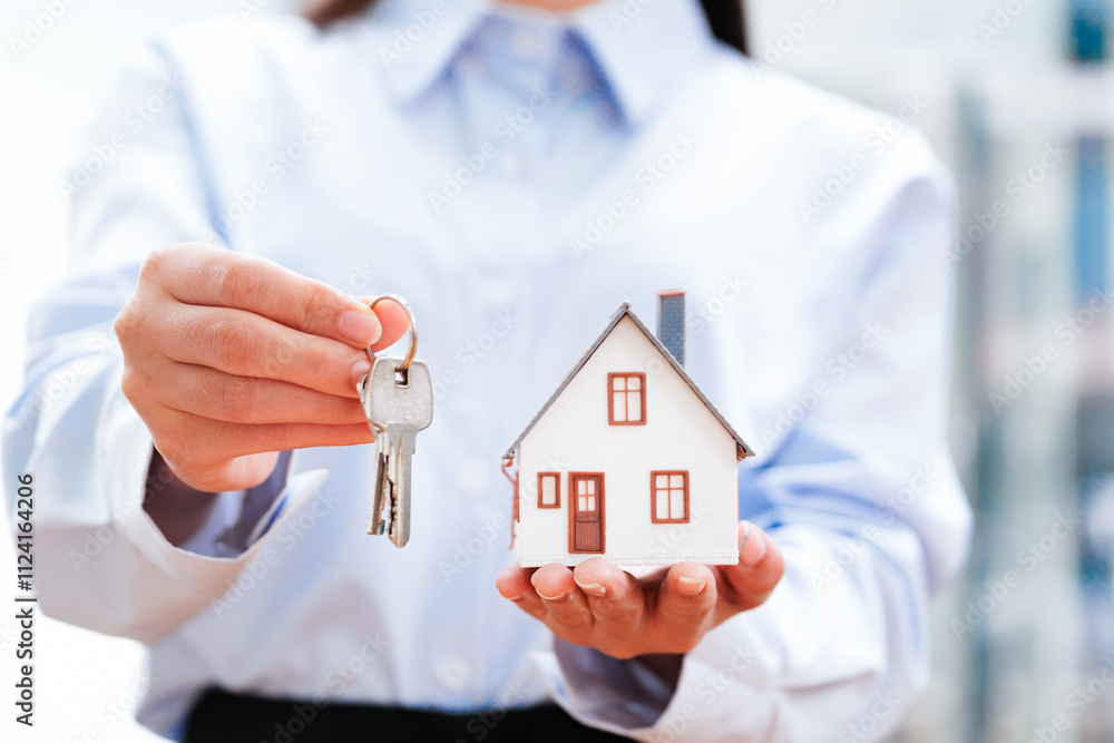 Real Estate Agent Holding House Model and Key Real Estate Agent Holding House Model and Key