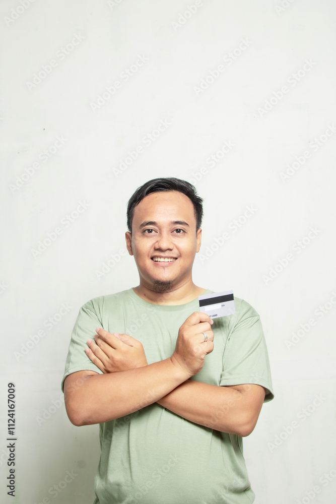 Muscular Asian man in light green shirt holding cards isolated on white backgroundGenerated image Muscular Asian man in light green shirt holding cards isolated on white backgroundGenerated image