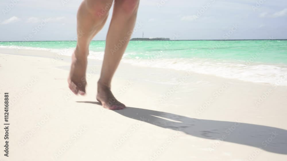 Sandy sea beach on an island, ocean, young woman runs along clean sand Sandy sea beach on an island, ocean, young woman runs along clean sand