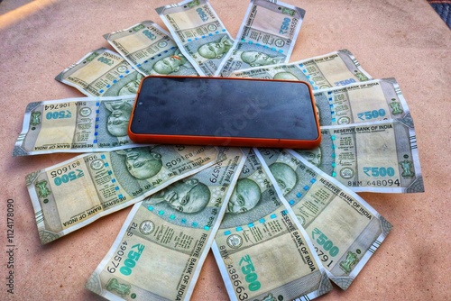 Indian 500 rupee notes with a phone in the center representing online payment, digital marketing, net banking, and financial technology concepts. photo