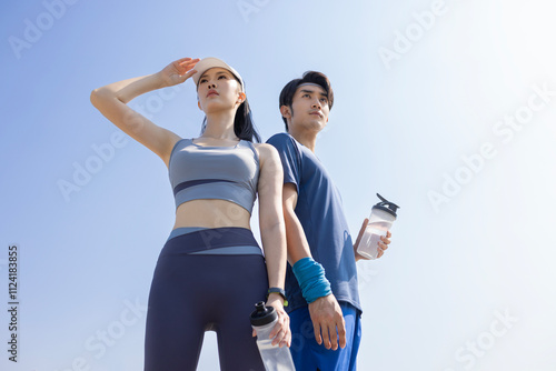 Young Chinese people holding water bottles