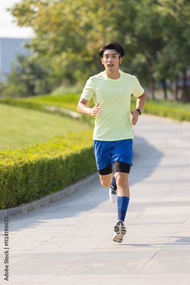 Young Chinese man exercising in a park