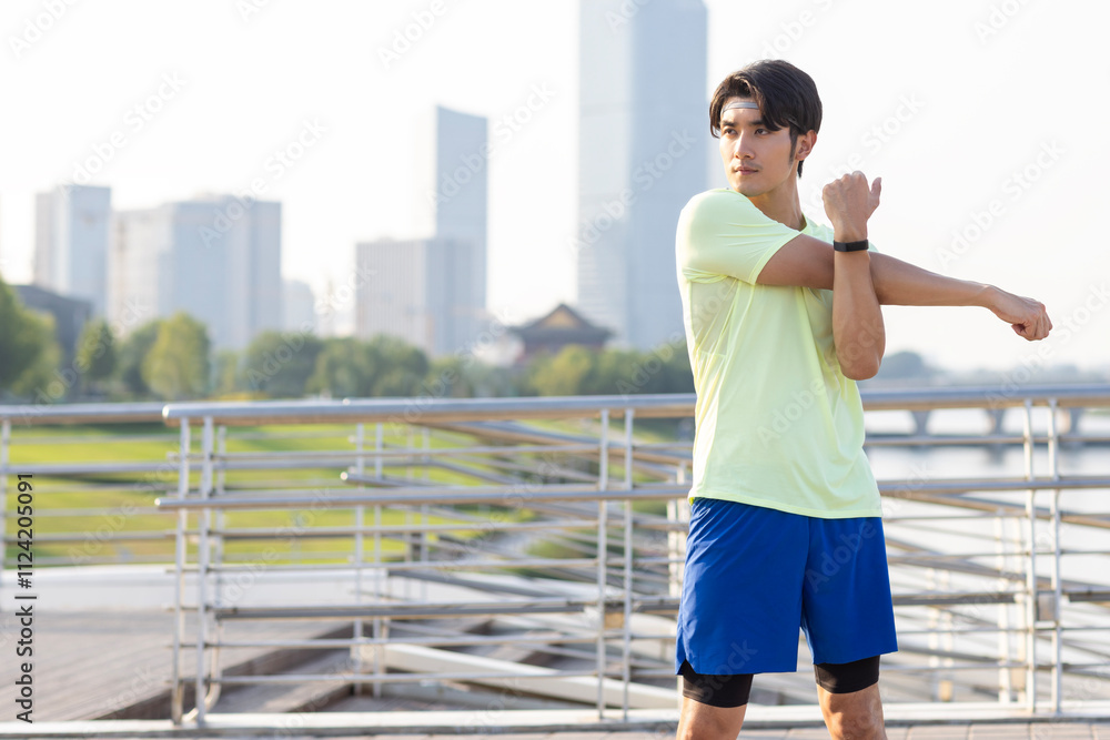 Young Chinese man exercising in a park